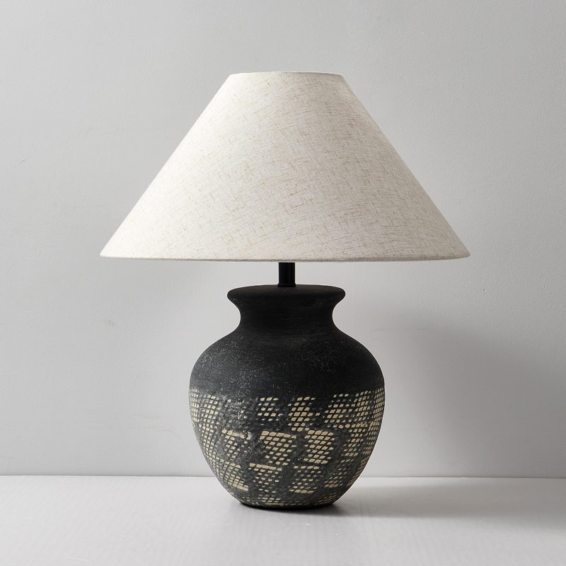 rustic-carved-ceramic-table-lamp-with-white-linen-drum-shade-and-handcrafted-earth-toned-finish