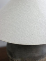 rustic-carved-ceramic-table-lamp-with-white-linen-drum-shade-and-handcrafted-earth-toned-finish