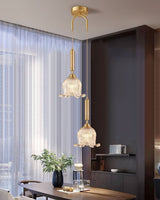 modern-brass-floral-pendant-light-with-clear-crystal-glass-shade-for-dining-areas