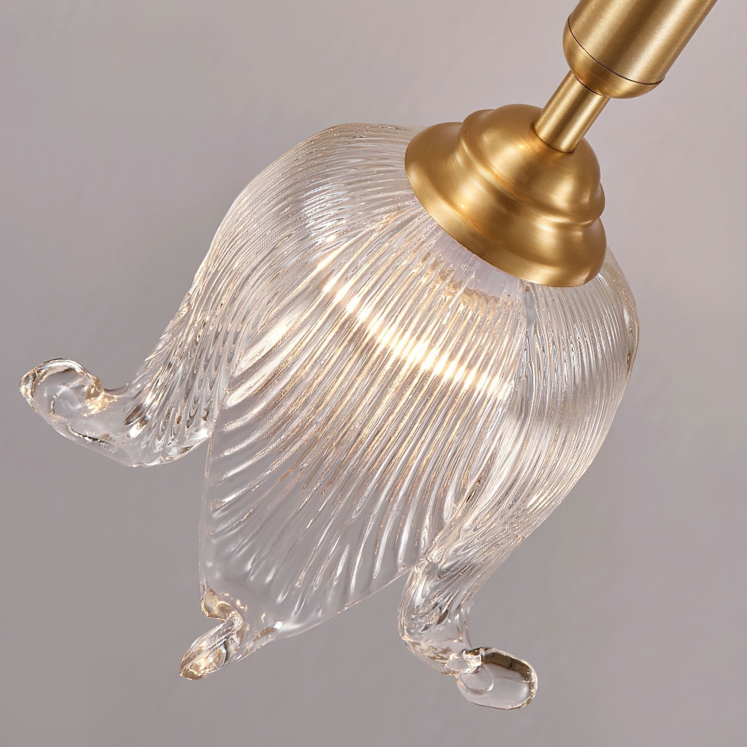 modern-brass-floral-pendant-light-with-clear-crystal-glass-shade-for-dining-areas