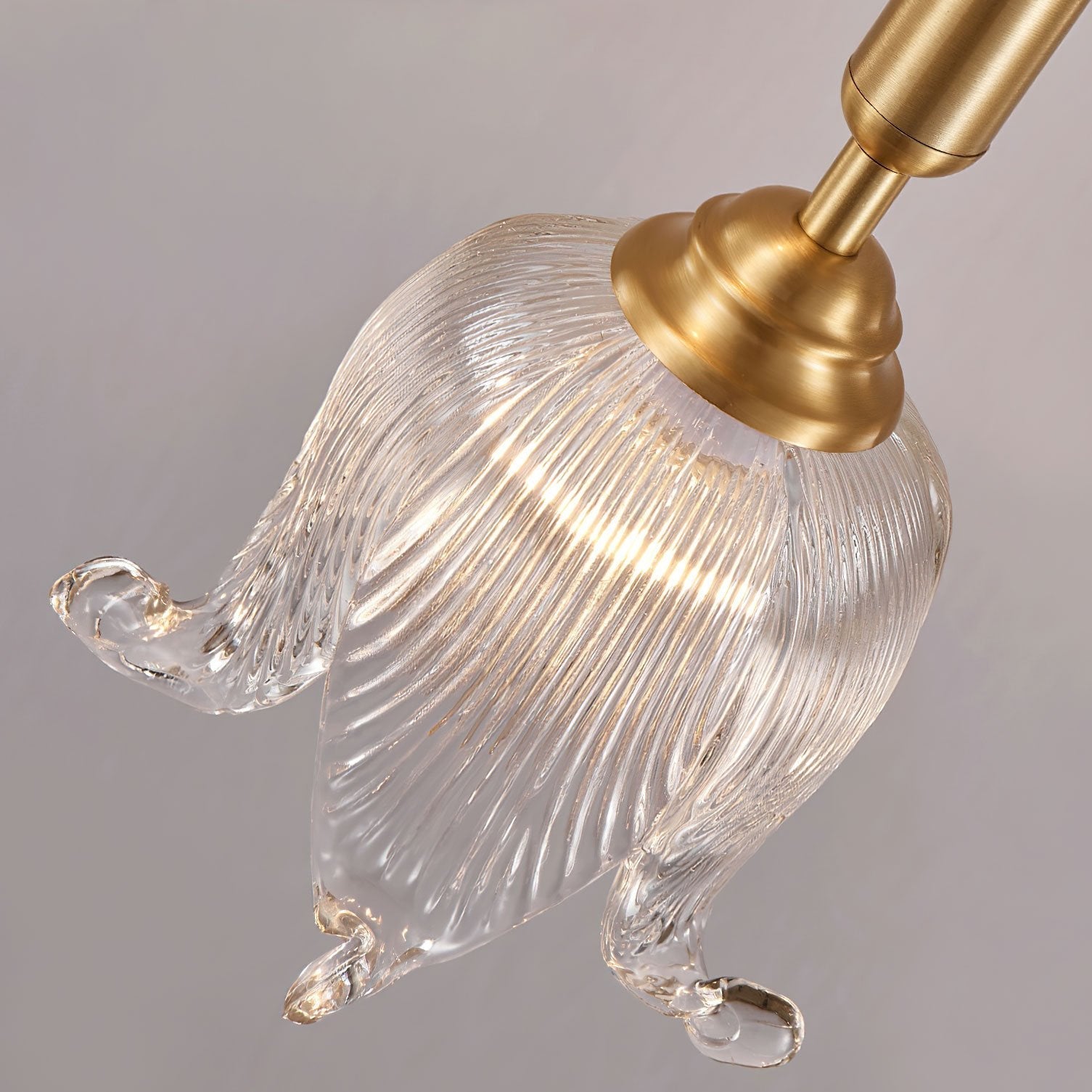modern-brass-floral-pendant-light-with-clear-crystal-glass-shade-for-dining-areas