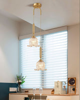 modern-brass-floral-pendant-light-with-clear-crystal-glass-shade-for-dining-areas