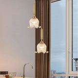 modern-brass-floral-pendant-light-with-clear-crystal-glass-shade-for-dining-areas