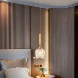 modern-brass-floral-pendant-light-with-clear-crystal-glass-shade-for-dining-areas