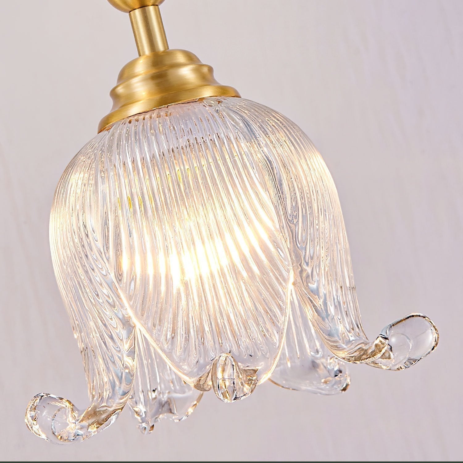 modern-brass-floral-pendant-light-with-clear-crystal-glass-shade-for-dining-areas