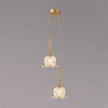 modern-brass-floral-pendant-light-with-clear-crystal-glass-shade-for-dining-areas