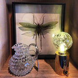 modern-crystal-glass-sphere-table-lamp-with-polished-brass-base-and-warm-led-glow