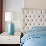 blue-ceramic-table-lamp-with-reactive-glaze-finish-and-white-linen-drum-shade