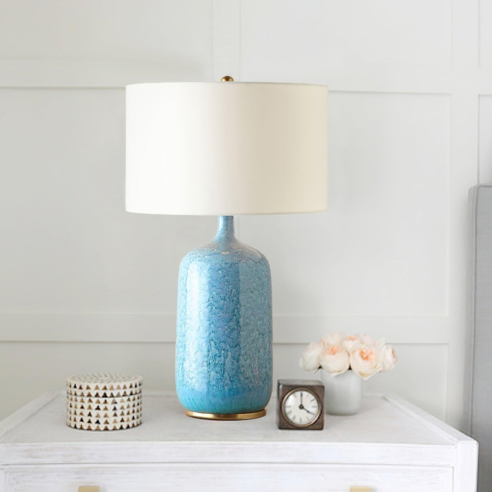 blue-ceramic-table-lamp-with-reactive-glaze-finish-and-white-linen-drum-shade