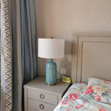 blue-ceramic-table-lamp-with-reactive-glaze-finish-and-white-linen-drum-shade