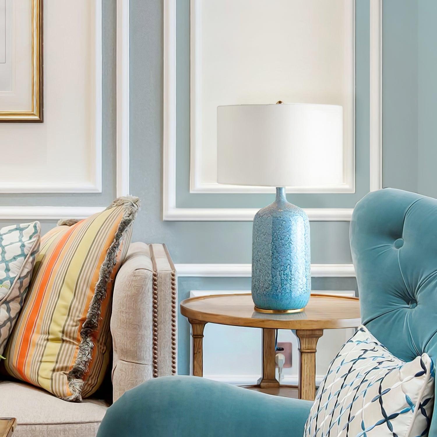 blue-ceramic-table-lamp-with-reactive-glaze-finish-and-white-linen-drum-shade