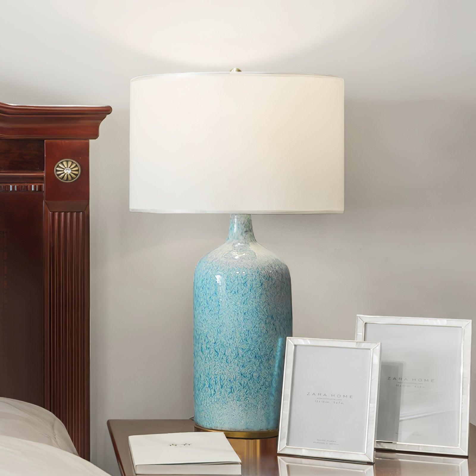 blue-ceramic-table-lamp-with-reactive-glaze-finish-and-white-linen-drum-shade