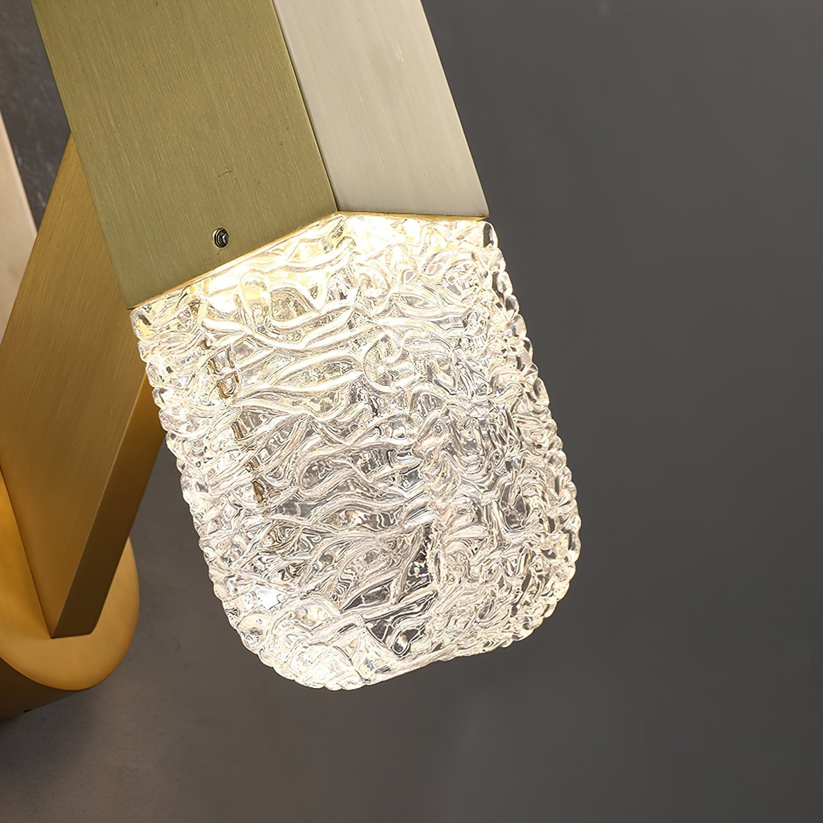 modern-luxury-oval-glass-wall-sconce-with-textured-ice-glass-and-brass-finish-integrated-led-lighting