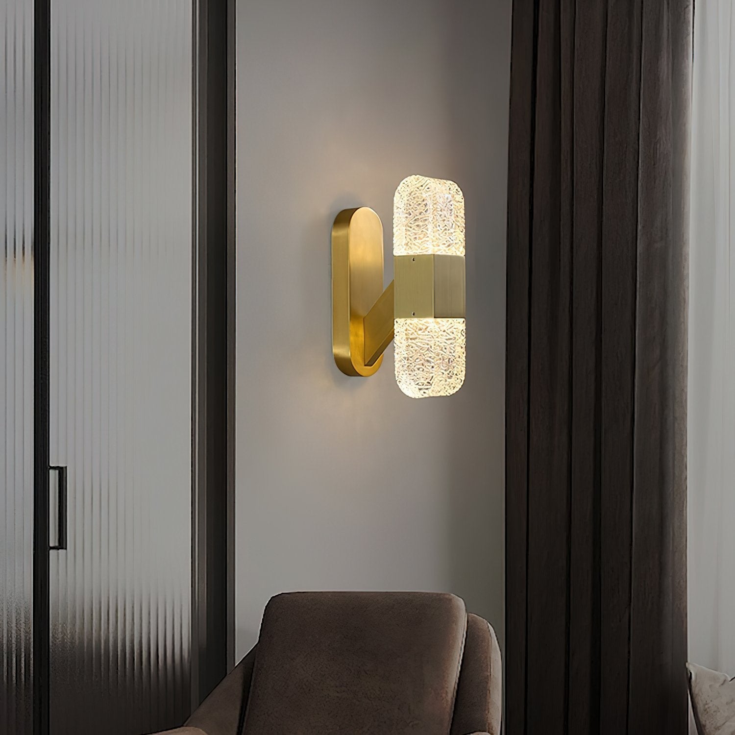 modern-luxury-oval-glass-wall-sconce-with-textured-ice-glass-and-brass-finish-integrated-led-lighting