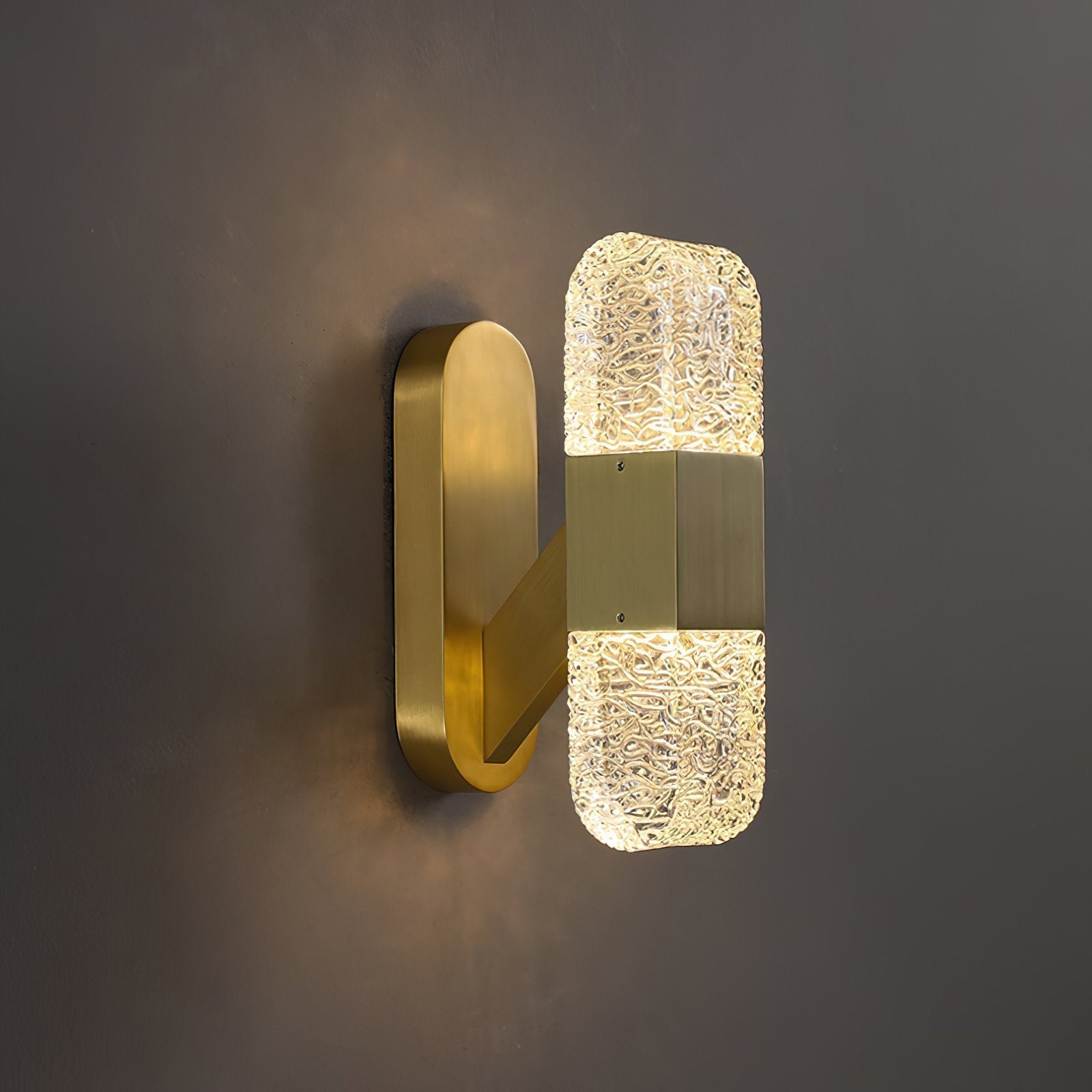modern-luxury-oval-glass-wall-sconce-with-textured-ice-glass-and-brass-finish-integrated-led-lighting