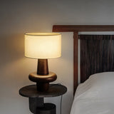 modern-eyelet-table-lamp-with-solid-wood-base-and-white-cloth-shade-for-bedside-lighting