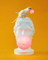 Modern Grace Portable Table Lamp with Pink Glass Globe and White Resin Bust Sculptural Base