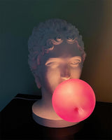 Modern Grace Portable Table Lamp with Pink Glass Globe and White Resin Bust Sculptural Base