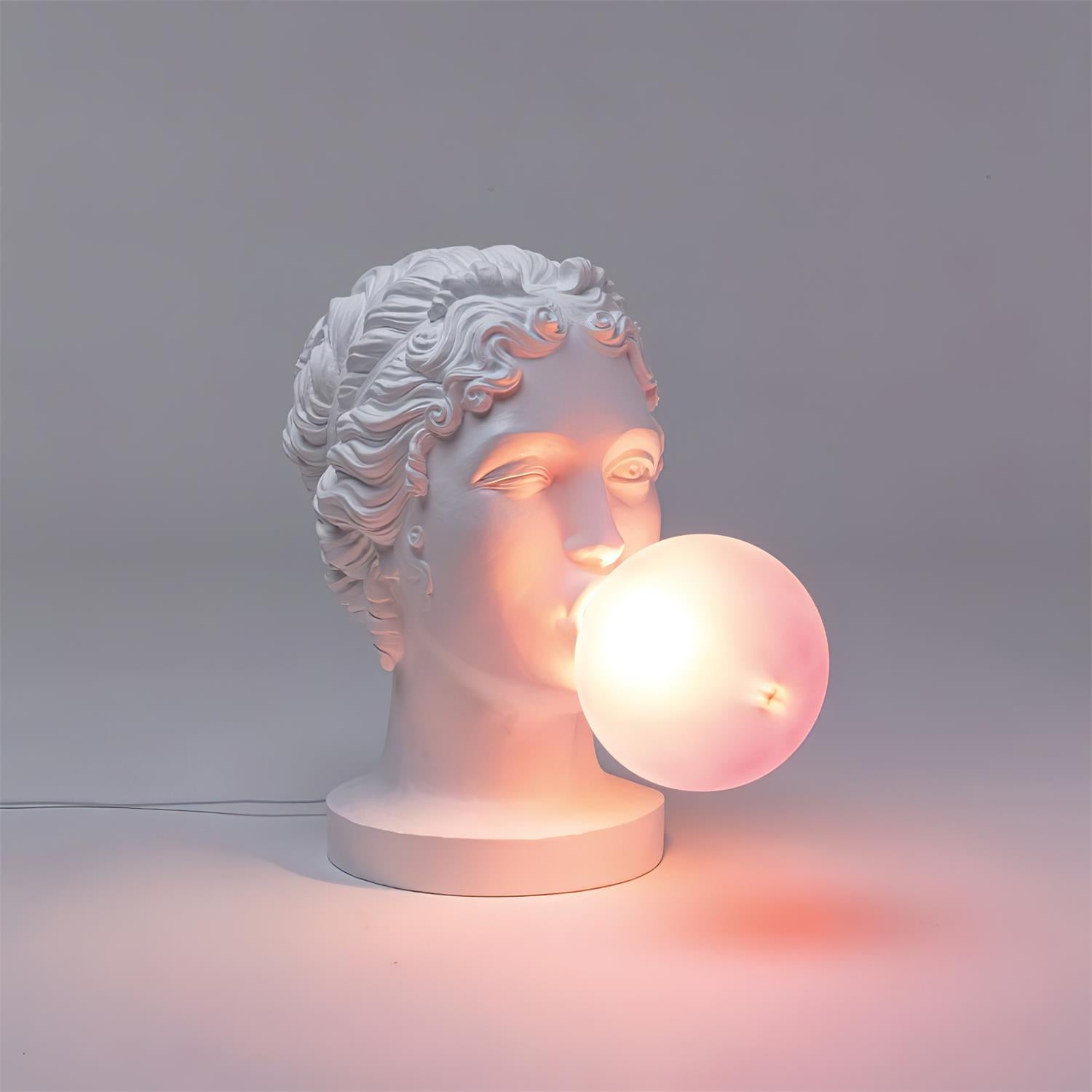 Modern Grace Portable Table Lamp with Pink Glass Globe and White Resin Bust Sculptural Base