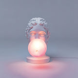 Modern Grace Portable Table Lamp with Pink Glass Globe and White Resin Bust Sculptural Base