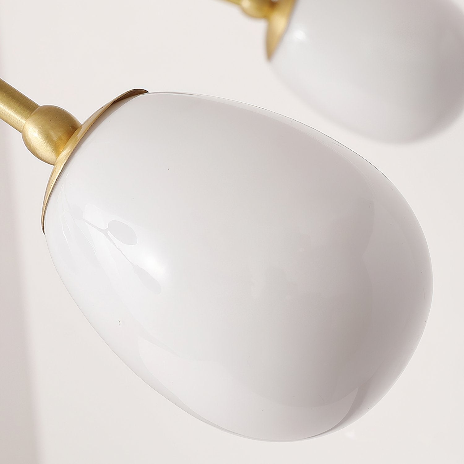 modern-brass-chandelier-with-pearl-glass-shades-and-elegant-curved-arms