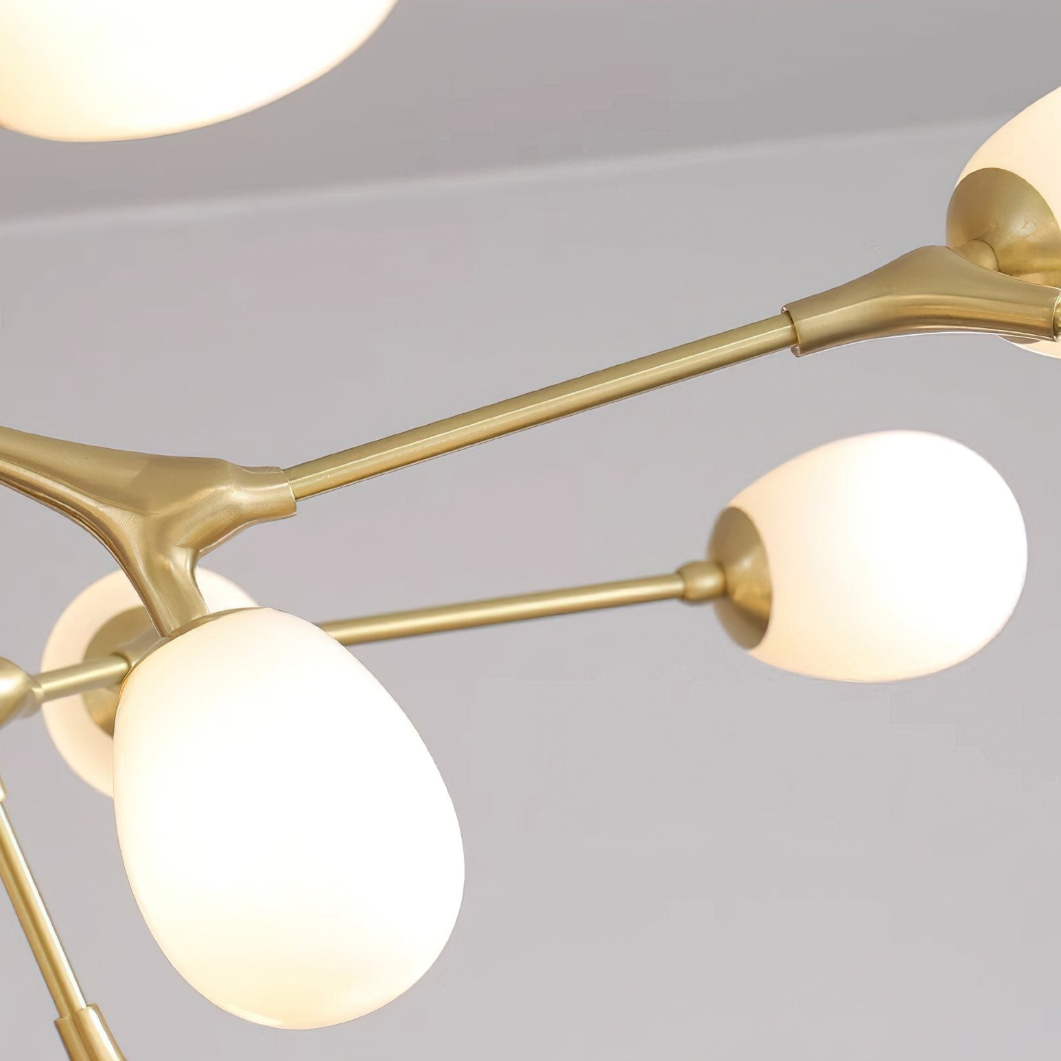 modern-brass-chandelier-with-pearl-glass-shades-and-elegant-curved-arms