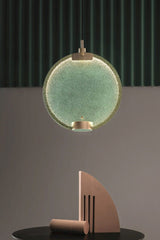 modern-circular-glass-pendant-light-with-brass-finish-and-integrated-led-spotlight