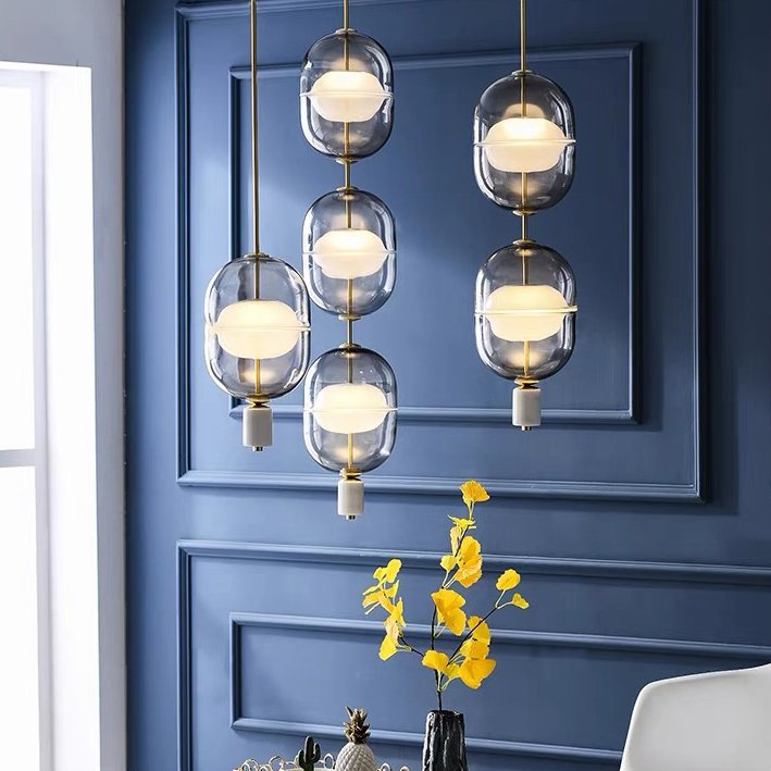 inder-nordic-glass-capsule-pendant-light-with-white-marble-and-metal-accents