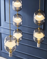 inder-nordic-glass-capsule-pendant-light-with-white-marble-and-metal-accents