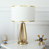 Laila Antique Gold Table Lamp with Ivory Fabric Shade and Curved Metal Base