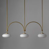mid-century-modern-looping-brass-pendant-light-with-white-blown-glass-globes