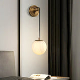 modern-alabaster-globe-wall-sconce-with-brass-accents-elegant-spherical-indoor-light