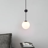 modern-brass-and-opal-glass-sphere-mobile-wall-sconce-lighting-for-indoor-spaces