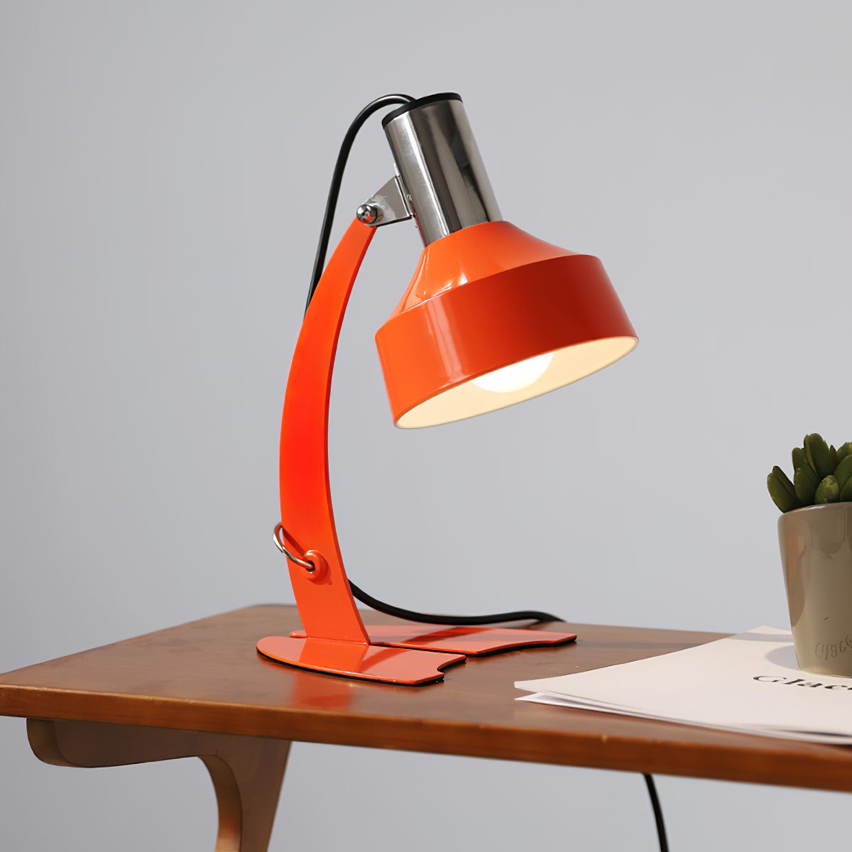 stylish-orange-and-chrome-metal-bedside-lamp-with-vibrant-apple-green-wire