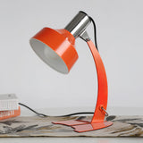 stylish-orange-and-chrome-metal-bedside-lamp-with-vibrant-apple-green-wire