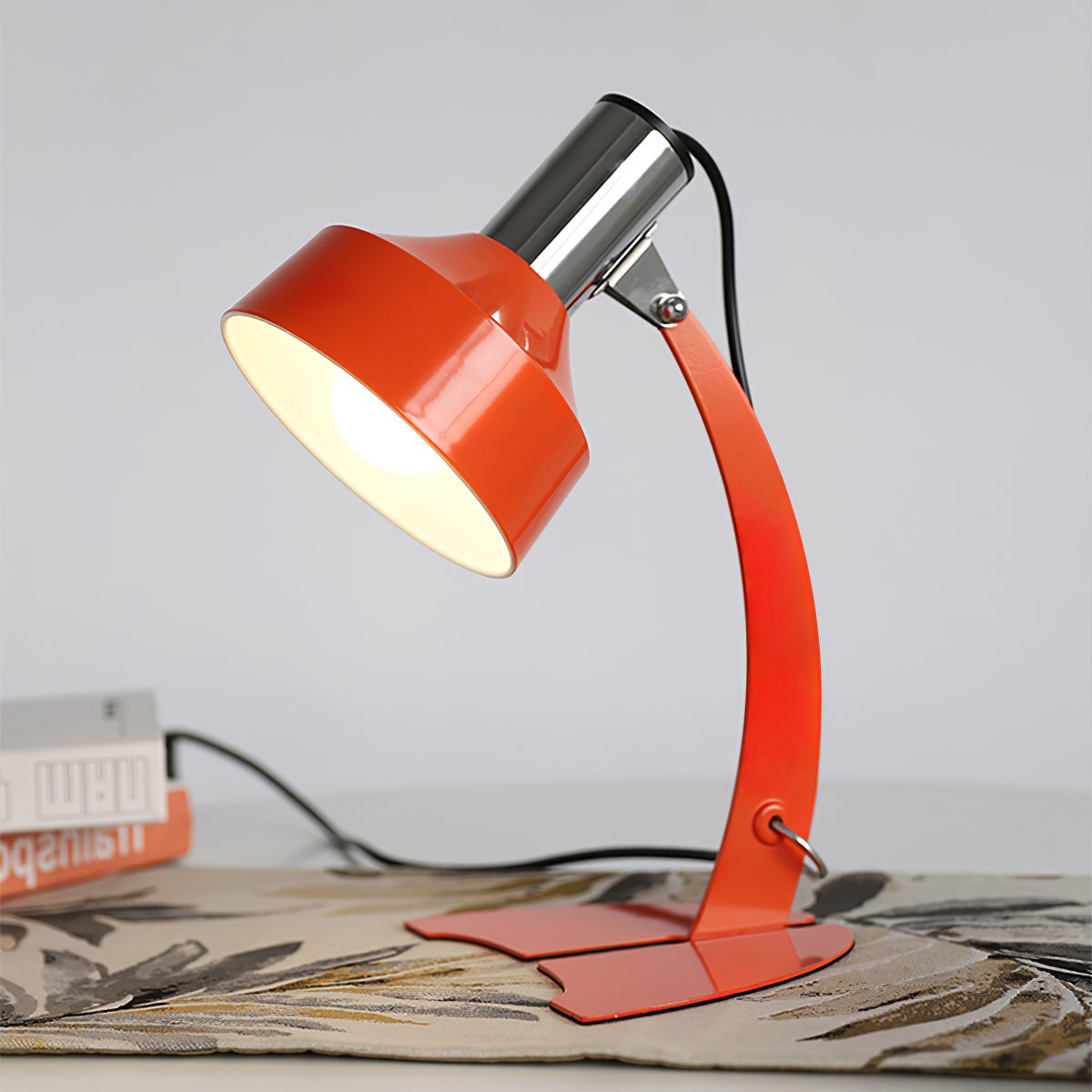 stylish-orange-and-chrome-metal-bedside-lamp-with-vibrant-apple-green-wire