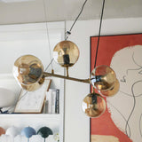 contemporary-multi-glass-globe-pendant-light-with-round-orb-shades-and-polished-brass-frame