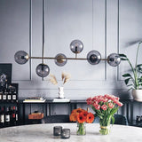 contemporary-multi-glass-globe-pendant-light-with-round-orb-shades-and-polished-brass-frame
