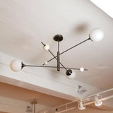 modern-orbital-3-arm-articulated-glass-globe-chandelier-in-copper-and-bronze-finish