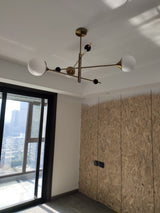 modern-orbital-3-arm-articulated-glass-globe-chandelier-in-copper-and-bronze-finish