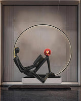 Modern Figurative Reader Sculpture LED Floor Lamp with Circular Frame and Ambient Lighting