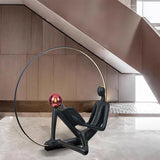 Modern Figurative Reader Sculpture LED Floor Lamp with Circular Frame and Ambient Lighting