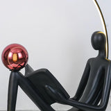 Modern Figurative Reader Sculpture LED Floor Lamp with Circular Frame and Ambient Lighting