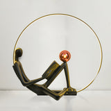 Modern Figurative Reader Sculpture LED Floor Lamp with Circular Frame and Ambient Lighting