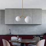 modern-asymmetric-glass-globe-pendant-light-with-brass-accents-and-hand-blown-glass