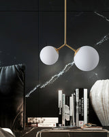 modern-asymmetric-glass-globe-pendant-light-with-brass-accents-and-hand-blown-glass