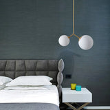 modern-asymmetric-glass-globe-pendant-light-with-brass-accents-and-hand-blown-glass