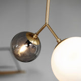 modern-asymmetric-glass-globe-pendant-light-with-brass-accents-and-hand-blown-glass