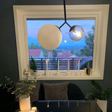 modern-asymmetric-glass-globe-pendant-light-with-brass-accents-and-hand-blown-glass