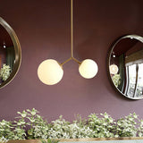 modern-asymmetric-glass-globe-pendant-light-with-brass-accents-and-hand-blown-glass